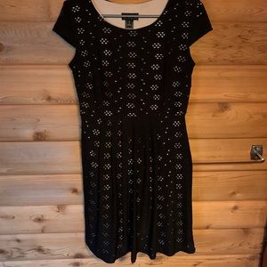 Black dress with eyelets over a nude underlay